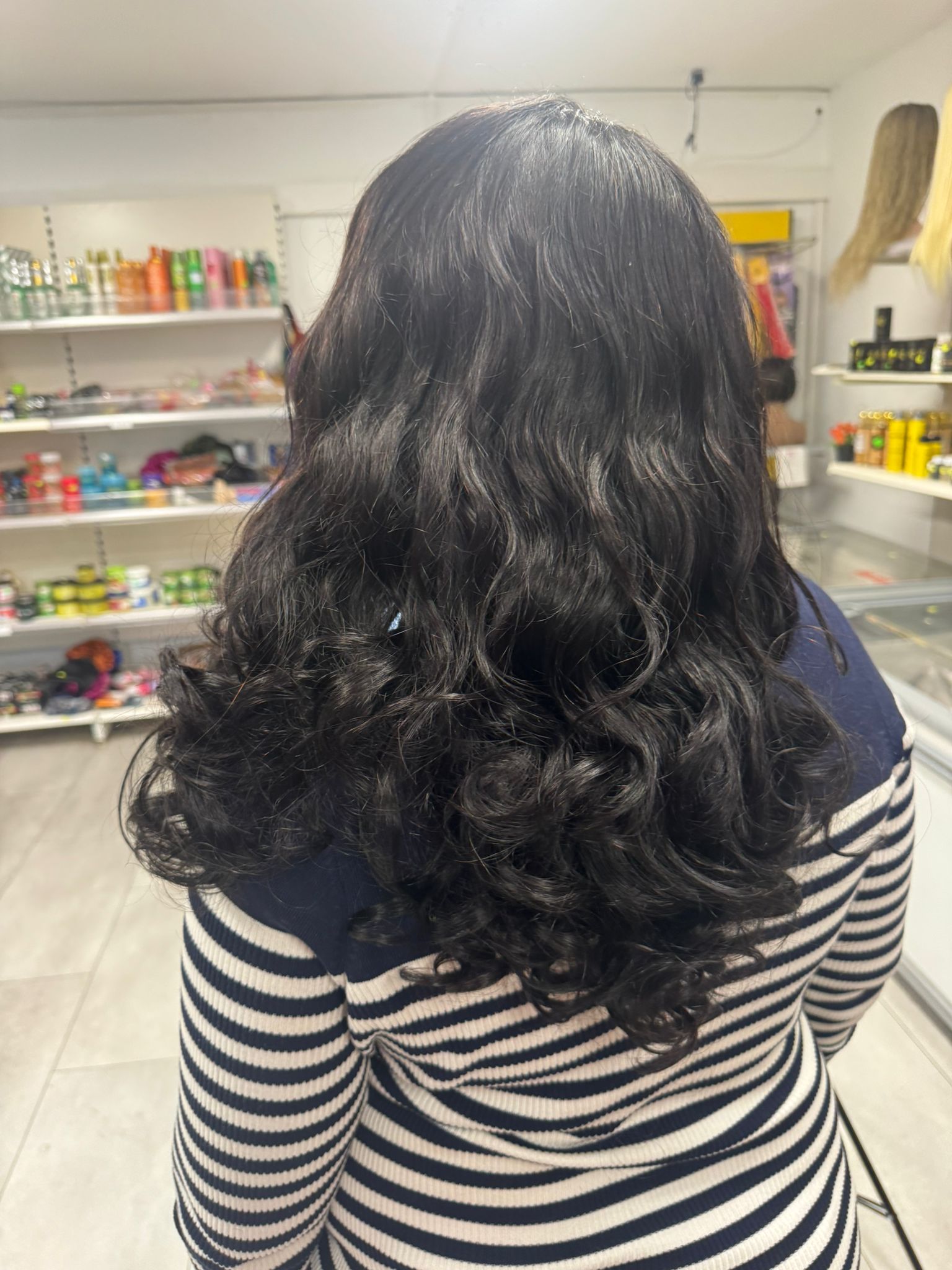 Long glossy waves styled at Makenene Afro Hair Salon